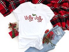 Holly Jolly Shirt for Women MADE TO ORDER!  Our UNISEX shirts are soft cotton, light and comfortable.  Refer to photos for the sizing chart; please size down for a more fitted tee. ~ PROCESSING TIME ~ Allow 2-4 business days for production. Allow 3-5 business days for shipping. (Usually 2-3 but please allow a few extra days to due USPS processing times) ~ SHIPPING ~ All orders ship via First Class or Priority USPS with tracking and usually 3-5 days in mail transit.  Please make sure your address is correct at checkout to avoid shipping delays.  We are NOT responsible for packages shipped to an old OR incorrect address given by the buyer.  It is important to double check your shipping address PRIOR to checkout, as this is what we ship to.  Refunds or replacements will not be issued for this Christmas Shirt Janmuse.com, Cheap White Christmas T-shirt, Affordable Christmas Letter Print T-shirt, Cheap Holiday T-shirt With Letter Print, Sleigh All Day, Winter Tees, Gigi Gift, Cute Christmas Shirts, Mommy Gift