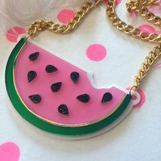 "This is a scrumptious necklace for all seasons! Bring the fun to any outfit with this big and bold watermelon necklace. This original design has been laser cut out of a mix of glitter, mirror, and opaque 1/8\" acrylic sheet and is backed with white, 1/16\" acrylic. The necklace hangs from a thick, gold chain and measures about 16\". We love these necklaces and think that they never get old. However, to prolong the life of yours, treat it with love! Be careful when storing it in a bag or pocket Watermelon Jewelry, Deprivation Tank, Watermelon Necklace, Glitter Mirror, Thick Gold Chain, Acrylic Necklace, Watermelon Slice, Watermelon Slices, Acrylic Sheets