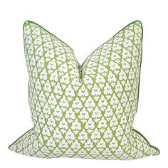 a green and white pillow on a white background