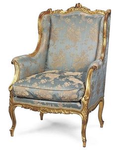 an ornately decorated chair with gold trimmings and blue upholstered fabric