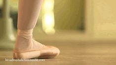 a ballerina's feet in ballet shoes on the floor