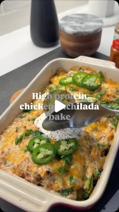 a casserole dish with green peppers and cheese being spooned into the casserole