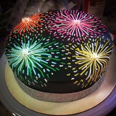 a cake decorated with fireworks on top of a table