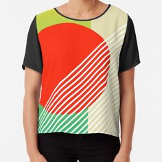 a women's top with an abstract design on the front and back, in red, green, yellow and white