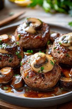 some very tasty looking meat covered in sauce on a plate with mushrooms and broccoli