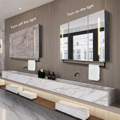 a bathroom with marble counter tops and mirrors on the wall, along with two sinks