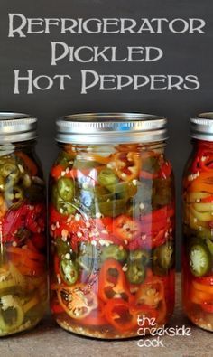 three jars filled with pickles and peppers