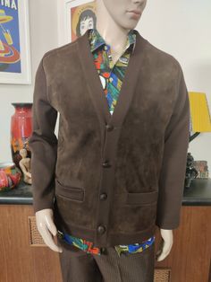 This is a rare find brown machine knit jacket with a suede leather front . It was made by Pierre Sangan of Jersey British Isles. The jacket is cardigan style, collarless with a V neck, four button closure with a spare inside the jacket should you loose one. It has two hip pockets. The condition is very good. The measurements are Chest 112cm Sleeves shoulder to cuff approx 65cm Length shoulder to hem 68cm Brown Single Breasted Sweater Coat With Long Sleeves, Brown Single Breasted Sweater Coat, Brown Single-breasted Long Sleeve Sweater Coat, Classic Brown Sweater Coat With Button Closure, Brown Sweater Coat With Buttons For Fall, Brown Buttoned Sweater Coat For Fall, Classic Fitted Brown Cardigan, Fitted Classic Brown Cardigan, Casual Brown Leather Blazer