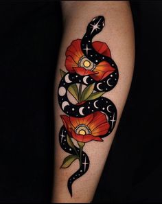 a woman's arm with tattoos on it and flowers in the shape of a snake