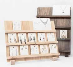 a wooden display case with earrings on it