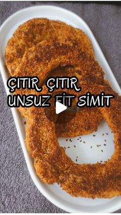 two onion rings sitting on top of a white plate with the words gitar gyr unsuz fit smith