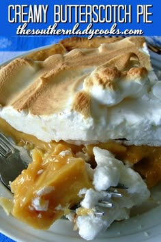 a piece of pie on a white plate with a fork and blue table cloth in the background