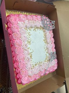 a pink and white cake in a box