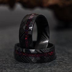 two black rings with red glitters on them