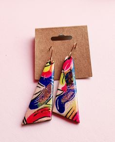 These earrings are sure to get attention, they are one of a kind and hand painted! They are bright and colorful making them easy to find something to match them! They are light weight despite their size, they have a wooden base and are sealed to last with high quality UV resin! They are also made using 14kt gold filled ear wires to ensure they are kind to even sensitive ears! All earrings come with their own jewelry polishing cloth!Each order is ships with USPS and a tracking # 💜 CARE INSTRUCTIONS 💜 Resin can be cleaned with soap and water. Your jewelry should be stored in an airtight bag or jewelry box that is in a cool, dry environment to protect from oxidation 💌 Please contact me with any questions.💌 ❣️ I do my best to ensure a quick and timely response! ❣️ Hand Painted Resin Earrings In Artsy Style, Colorful Hand-painted Drop Earrings, Colorful Hand Painted Drop Earrings, Colorful Hand Painted Earrings As Gift, Colorful Hand Painted Earrings For Gift, Hand Painted Colorful Earrings For Gifts, Vibrant Handmade Gold Earrings, Hand Painted Resin Earrings, Artsy Hand Painted Colorful Earrings