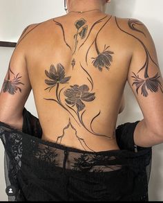 the back of a woman with tattoos on her body