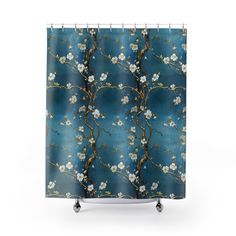 a blue shower curtain with white flowers and branches in bloom on a dark blue background