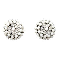 1950s rhodium plated prong set cabochon white rhinestone and round clear rhinestones clip earrings. Marked "Kramer of N.Y." Measure: 15/16 inches across. Condition: Very good; minor wear to backs.  During the 1950s Kramer also produced jewelry for Christian Dior. Silver Jeweled Clip-on Earrings, White Crystal Clip-on Earrings For Anniversary, Silver Round Clip-on Crystal Earrings, Silver Clip-on Cluster Earrings For Evening, Silver Round Clip-on Earrings For Evening, Silver Round Clip-on Earrings With Sparkling Stones, Vintage Silver Jeweled Clip-on Earrings, Vintage Silver Clip-on Earrings With Sparkling Stones, Silver Clip-on Earrings For Vintage Events