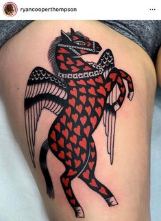 a woman's thigh with a black and red tattoo design on it