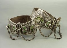 "Pair of Amazigh/Berber cast silver anklets inspired from the oldest Meknes and Fez types, probably made in Marrakesh or Essaouira. Made of high-grade silver. The green enamel could be a later addition. The ram's head hallmark indicates it is post-1925, from around mid 20th century. Dimensions: Diameter: 8 cm (3,15 inches) Width (widest point): 5 cm (1,97 inches) Weight: 360 gr. References: \"Bijoux du Maroc\", Rabaté, Marie-Rose-Golderberg, André, Editions Eddif, 1999 \"Bijoux Berbéres Au Marro Berber Jewelry, 1950s Bracelet, Moroccan Jewelry, Silver Anklets, Silver Work, Green Enamel, Anklet Jewelry, Ethnic Jewelry, Photo Jewelry