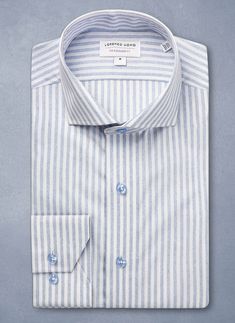 The Alexander in Mélange Blue Stripe Shirt is reminiscent of Venetian gondoliers’ stripes on a sunny day. The unique heather blue in the stripes offer a purely unique, custom look. Made with pure, super soft cotton, and paired with the periwinkle-colored buttons, this shirt exudes refined and understated elegance. Can be dressed up under a blazer or worn untucked, for a more casual, after-hours look. The Alexander is the trimmest of all our fits, calibrated to accentuate a lean, athletic body ty Blue Shirt With Horizontal Stripes For Summer, Classic Blue Horizontal Stripe Tops, Classic Blue Horizontal Stripe Top, Blue Cotton Shirt With Horizontal Stripes, Athletic Body Type, Athletic Body, Stripe Shirt, Heather Blue, Understated Elegance