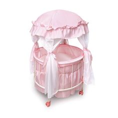 a pink baby crib with a canopy over it