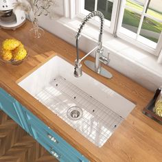 a kitchen sink sitting on top of a wooden counter