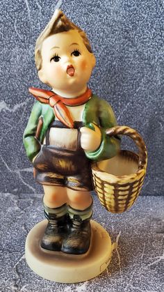 a ceramic figurine holding a basket