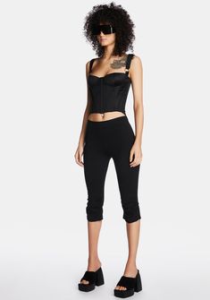 life goes on. These high-waisted pedal pusher pants have ruched legs, a side zip closure, and a bodycon fit. Black Cropped Elastane Bottoms, Chic Black Capri Pants, Chic Black Capri Length Pants, Fitted Black Cropped Bottoms, Black Fitted Cropped Bottoms, High Stretch Black Capris, Black Elastane Capri-length Bottoms, Black Fitted Capris For Spring, Chic Fitted Black Capris