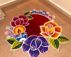 a decorated floor with flowers and candles on it