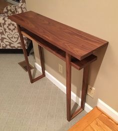 a wooden table sitting on top of a carpeted floor