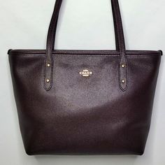 Like New! Beautiful Deep Purple/Brown In Color (Oxblood). Leather Exterior. Full Zip Closure. Gold Tone Hardware. Lined Interior With Two Slip Pockets. Brand: Coach Measurements: 13"L X 8"H X 4"W Posh Ambassador Top Rated Seller Fast Shipper Reasonable Offers Accepted Classic Purple Shoulder Bag, Classic Purple Leather Shoulder Bag, Classic Purple Bag With Branded Hardware, Classic Purple Bags With Branded Hardware, Classic Purple Bag For Everyday Use, Classic Purple Bags For Everyday Use, Classic Everyday Purple Bag, Classic Purple Shoulder Bag For Everyday, Classic Purple Everyday Bag