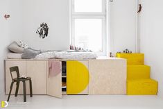 a bed sitting on top of a wooden shelf next to a window