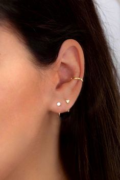 "Dainty open huggie hoop earrings featuring a tiny dot or a tiny triangle. Simple, tiny and versatile, they're perfect for wearing in a first or second piercing, on a cartilage piercing or all by themselves for the tiniest addition to your everyday look. ** Available with a tiny triangle OR a tiny dot. Choose your preference on the dropdown menu. ** Sold individually (1 earring) or as a pair (2 earrings) * D E T A I L S * ∙ Material: .925 Sterling Silver or 18K Gold Plated over .925 Sterling Sil Minimalist Triangle Jewelry For Pierced Ears, Minimalist Triangle Jewelry, Modern Huggie Piercings As Gift, Minimalist White Ear Cuff, Modern Huggie Piercings For Gift, Everyday White Huggie Cartilage Earrings, Minimalist White Cartilage Earrings, White Minimalist Cartilage Earrings, Minimalist White Pierced Cartilage Earrings