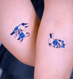 two tattoos on the legs of people with blue flowers and elephants painted on their thighs