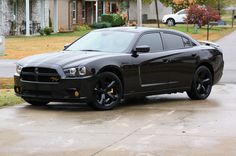 a black car parked in front of a house