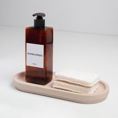 a bottle of soap sitting on top of a tray