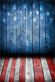 an american flag painted on wooden planks in front of a blue wall with stars