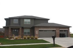 a large house with two garages in the front yard