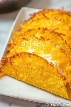 a cheesy dish on a white plate with orange zest and cheese toppings