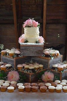 a table topped with lots of cupcakes and cakes