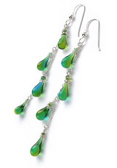 Dangling yet dainty, these fun silver and glass drop earrings conjure visions of flowering vines. Nickel-free Glass Drop Jewelry, Glass Drop Earrings With Matching Set, Sterling Silver Drop Jewelry With Dangling Charms, Wire Wrapped Drop Jewelry For Party, Fusion Style Sterling Silver Dangle Chandelier Earrings, Sterling Silver Fusion Chandelier Dangle Earrings, Green Wire Wrapped Long Drop Earrings, Silver Drop Glass Jewelry, Wire Wrapped Long Drop Linear Earrings