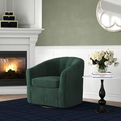 a green chair sitting in front of a fire place next to a vase with flowers