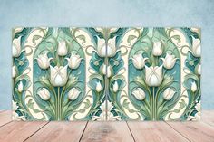 a wooden table topped with an artisticly designed tile wallpaper covered in white tulips