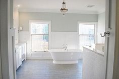 a large white bath tub sitting inside of a bathroom