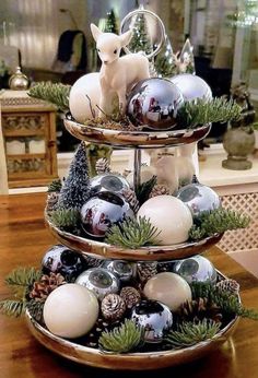 three tiered trays filled with ornaments on top of a table