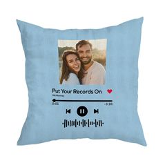 a blue pillow with an image of a man and woman holding each other's head