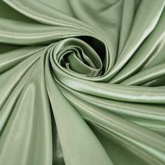 a close up view of a green satin fabric with very thin lines on the edges