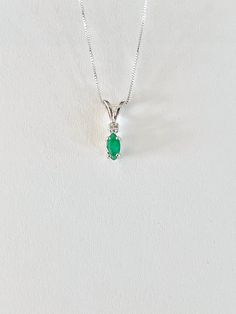 Genuine natural SMALL marquise shaped emerald measures 6 x 3.5mm (1/3 carat). Genuine tiny 2mm accent diamond. Both stones were handset in sterling silver. Sterling silver box chain is 18 inches long and can be switched to a 16 inch chain upon request. Necklace is perfect for a child or the minimalist. Comes in a gift box Green Pendant Necklace With Prong Setting, Green Pendant Necklaces With Prong Setting, Green Emerald Diamond Necklace For May Birthstone, Classic Green Diamond Pendant Necklace, Green Necklaces With Prong Setting For May Birthstone, Green Pendant Diamond Necklace In Classic Style, Classic Green Pendant Diamond Necklace, Classic Green Emerald Pendant Necklace, Pendant Necklace With May Birthstone In Prong Setting