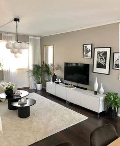 a living room filled with lots of furniture and pictures on the wall above it's tv